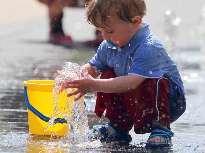 Faszinierendes Wasser: Dies denkt sich wohl der einjährige Jonny Luca bei dem Weseler Wasserspiel. 