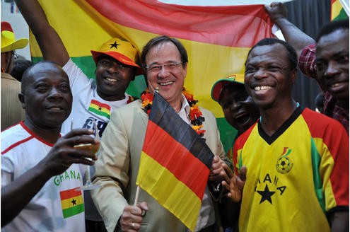 Der ehemalige Integrationsminister feiert gemeinsam mit ghanaischen Fußballfans während einer Übertragung des WM-Spiels Deutschland gegen Ghana.