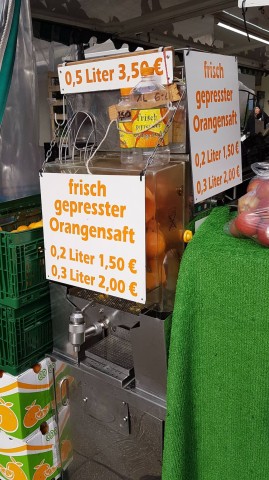 An dem Stand können Kunden frischgepressten Orangensaft in drei Mengen kaufen.