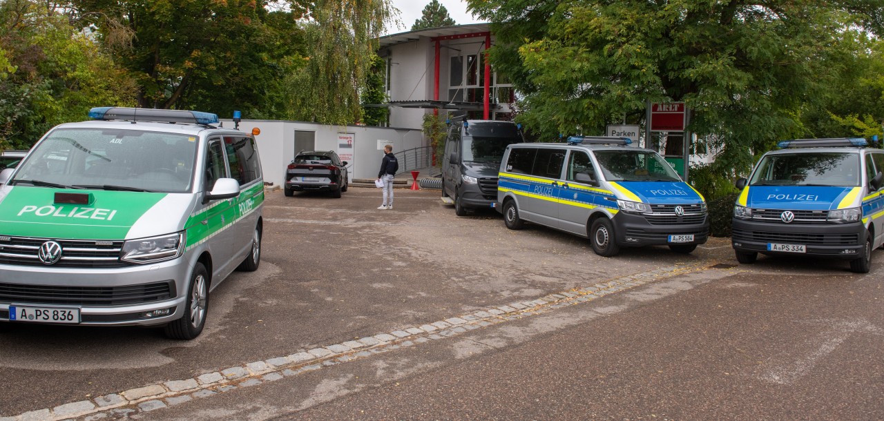 Polizeifahrzeuge stehen vor dem Impfzentrum. Dort müssen Patienten eines Arztes aus dem Landkreis Donau-Ries  sich einem Antikörpertest unterziehen.