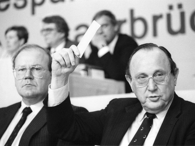 Im Jahr 1985 gibt Genscher wegen der Kritik an seinem Führungsstil sein Amt als FDP-Parteivorsitzender an Bundeswirtschaftsminister Martin Bangemann (li.) ab. 