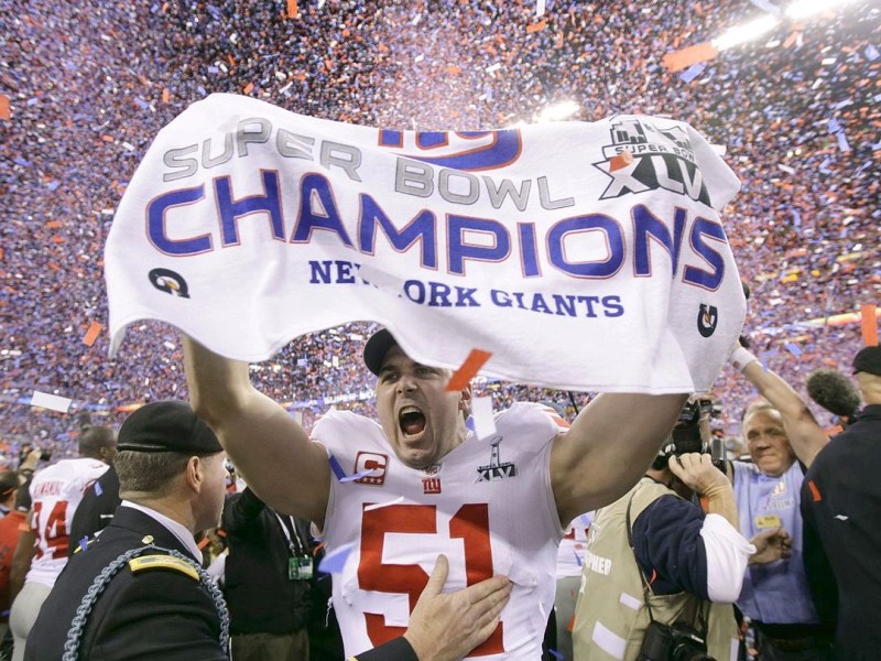 New York Giants long snapper Zak DeOssie (51) celebrates after his team's 21-17 win over the New England Patriots in the NFL Super Bowl XLVI football game, Sunday, Feb. 5, 2012, in Indianapolis. (AP Photo/Marcio Jose Sanchez)