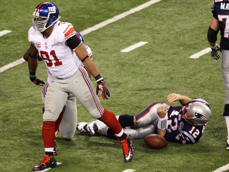 New York Giants defensive end Justin Tuck (91) reacts after sacking New England Patriots quarterback Tom Brady during the second half of the NFL Super Bowl XLVI football game, Sunday, Feb. 5, 2012, in Indianapolis. (AP Photo/Charlie Riedel)