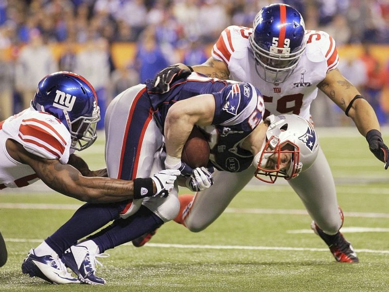 New England Patriots wide receiver Wes Welker (83) is stopped by New York Giants linebackers Jacquian Williams, left, and Michael Boley during the second half of the NFL Super Bowl XLVI football game, Sunday, Feb. 5, 2012, in Indianapolis. (AP Photo/Mark Humphrey)