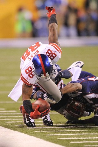 Hakeem Nicks of the New York Giants is upended in the first quarter of Super Bowl XLVI against the New England Patriots on February 5, 2012 at Lucas Oil Stadium in Indianapolis, Indiana. AFP PHOTO / TIMOTHY A. CLARY
