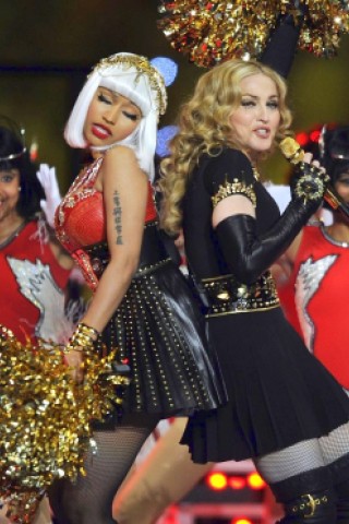 Singer Madonna (L) and Nicki Minaj perform during the NFL Super Bowl XLVI game halftime show on February 5, 2012 at Lucas Oil Stadium in Indianapolis, Indiana. AFP PHOTO / TIMOTHY A. CLARY