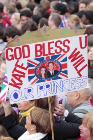 Mit Schildern grüßen die Menschen in London William und Kate.