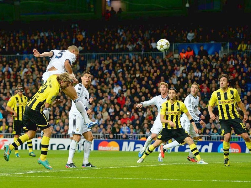 MADRID, SPAIN - NOVEMBER 06:  Pepe of  Madrid heads his team's first goal during the UEFA Champions League Group D match between Real Madrid and Borussia Dortmund at Estadio Santiago Bernabeu on November 6, 2012 in Madrid, Spain.  (Photo by Dennis Grombkowski/Bongarts/Getty Images)