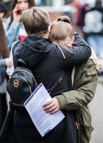 Eine Schülerin liegt einer Frau auf dem Schulhof der Käthe Kollwitz Gesamtschule in Lünen in den Armen.