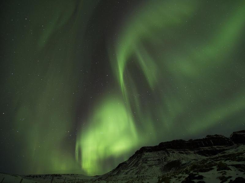 Polarlichter über der Stadt Bifrost in Island.