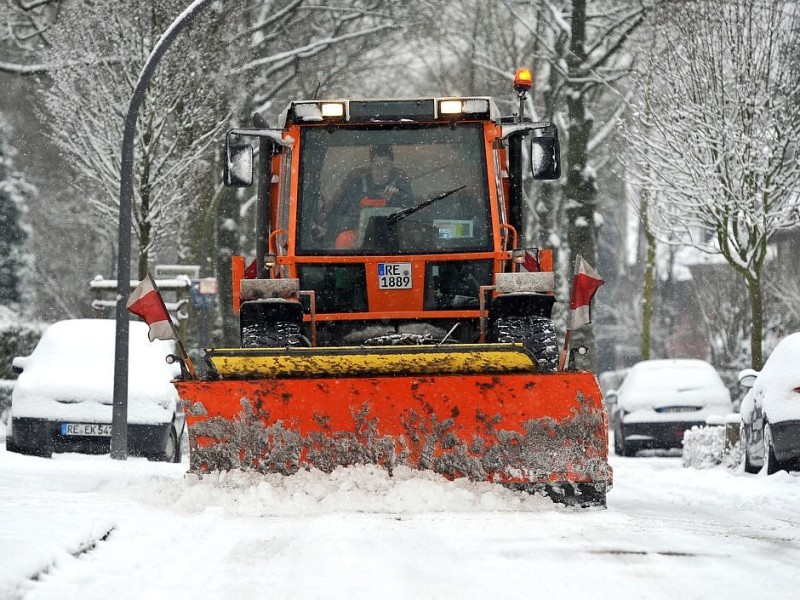 Ein Streu- und Räumwagen der KSR im Recklinghäuser Nordviertel beim Schneeräumen und Salz streuen.