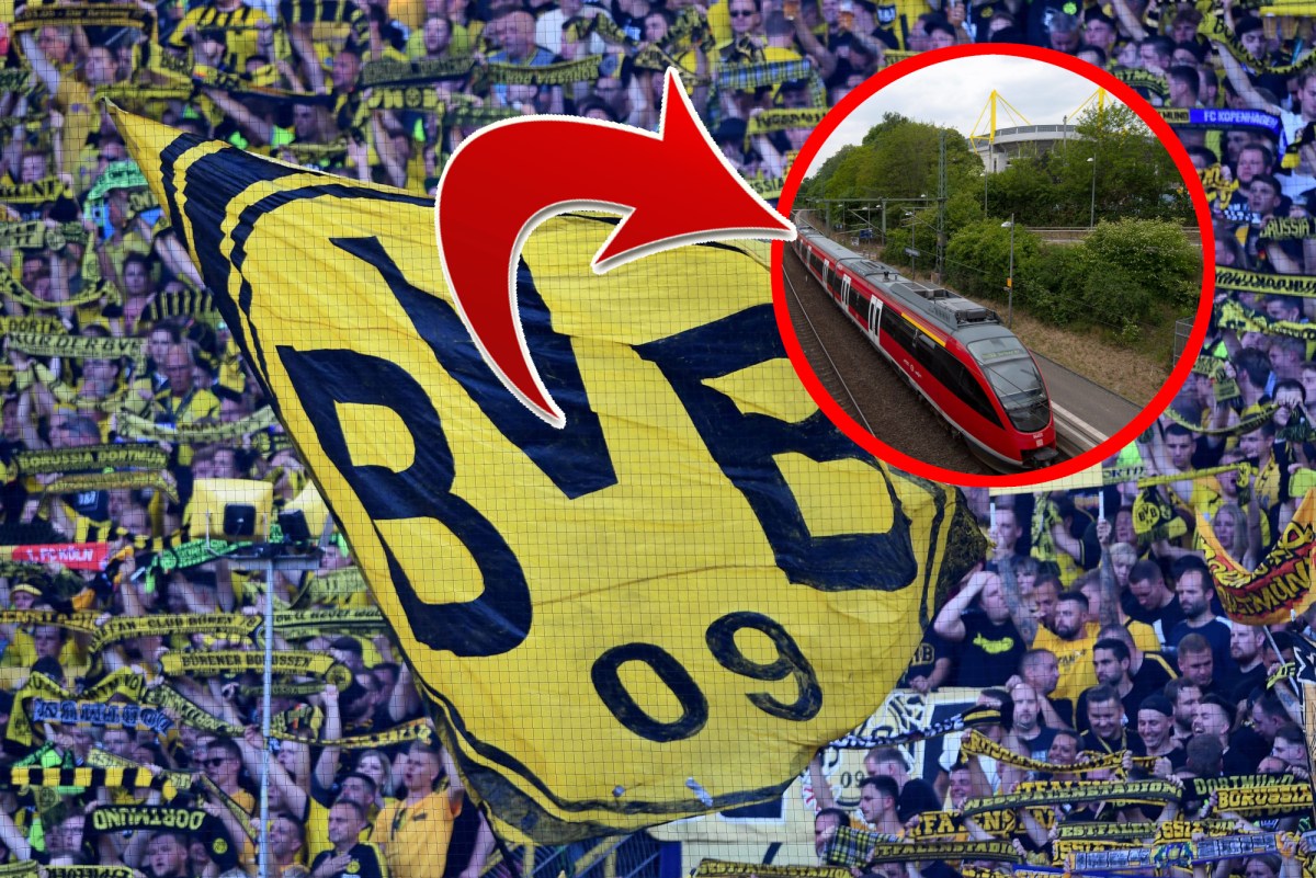 Fans von Borussia Dortmund schwenken eine Fahne auf der Südtribüne.
