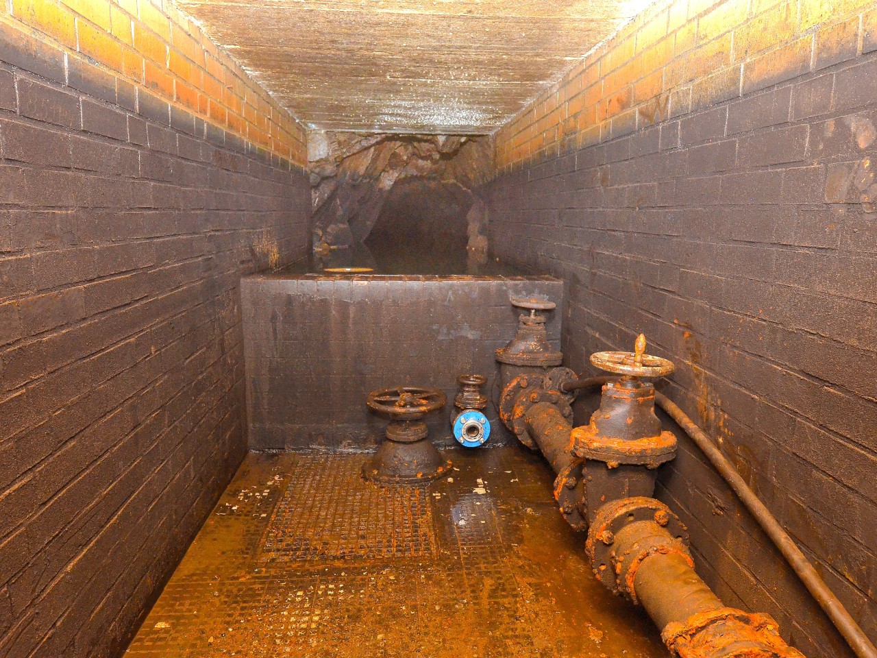 Schön spannend und geheimnisvoll: Hinter der etwa 2,5 Meter breiten und 1,2 Meter hohen Mauer, vor der die abfließenden Wassermengen reguliert werden können, staut sich das Wasser tief in den Stollen hinein. Ein Begehen hinter der Mauer wäre lebensgefährlich.